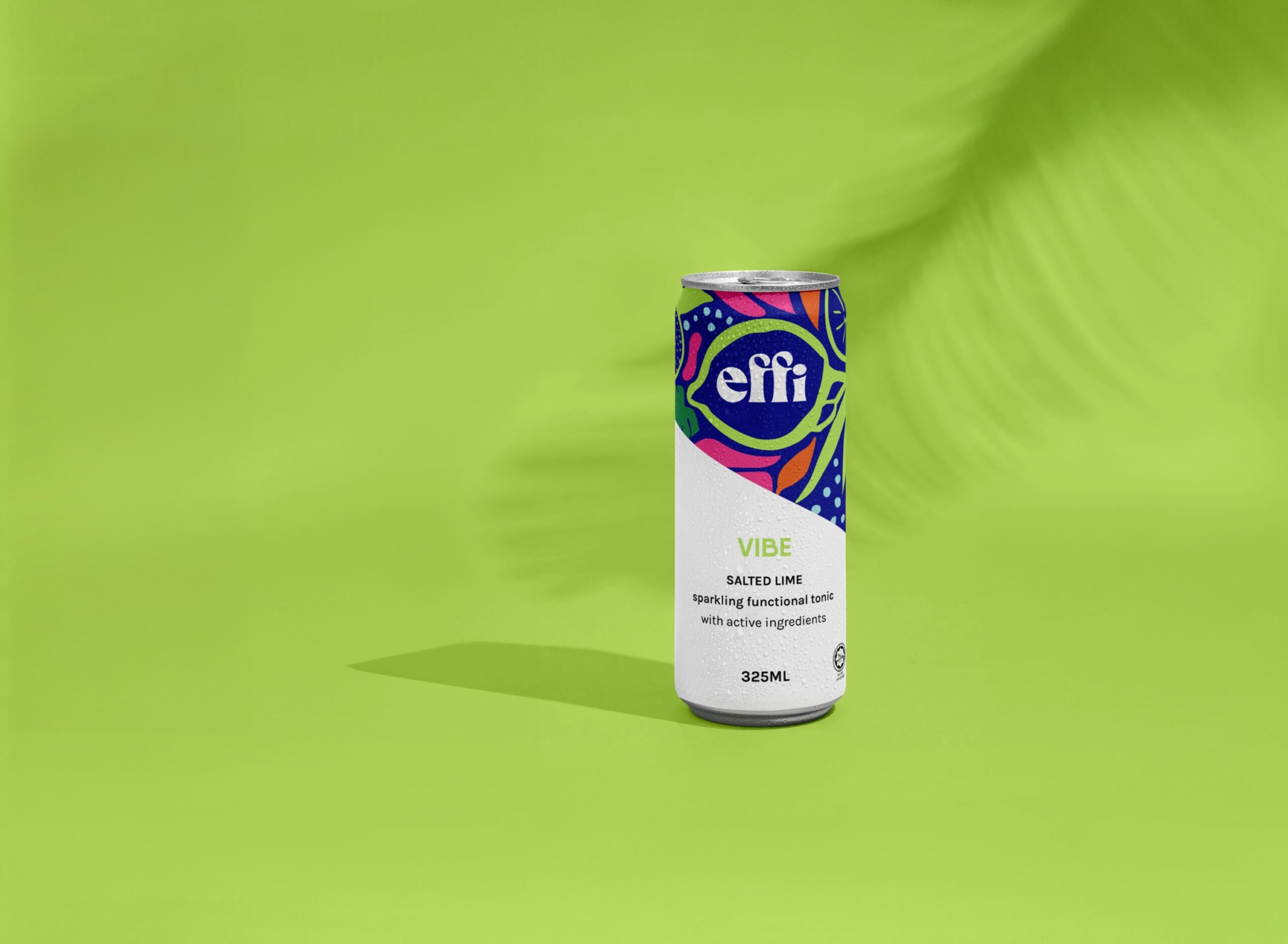 A can of effi VIBE functional soda resting on a lime-green surface with palm-leaf shadows